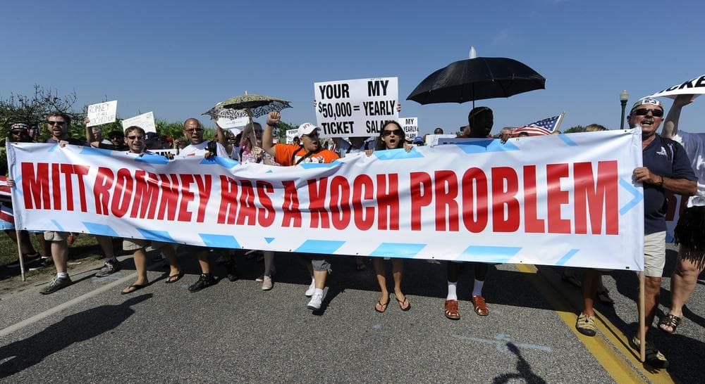 Protestors from the Occupy Movement, MoveOn.org and the Long Island Progressive march to the beachfront home of industrial billionaire David H. Koch to demonstrate against a fundraiser for Mitt Romney held at Koch's home on Sunday, July 8, 2012, in Southampton, N.Y. (AP Photo)
