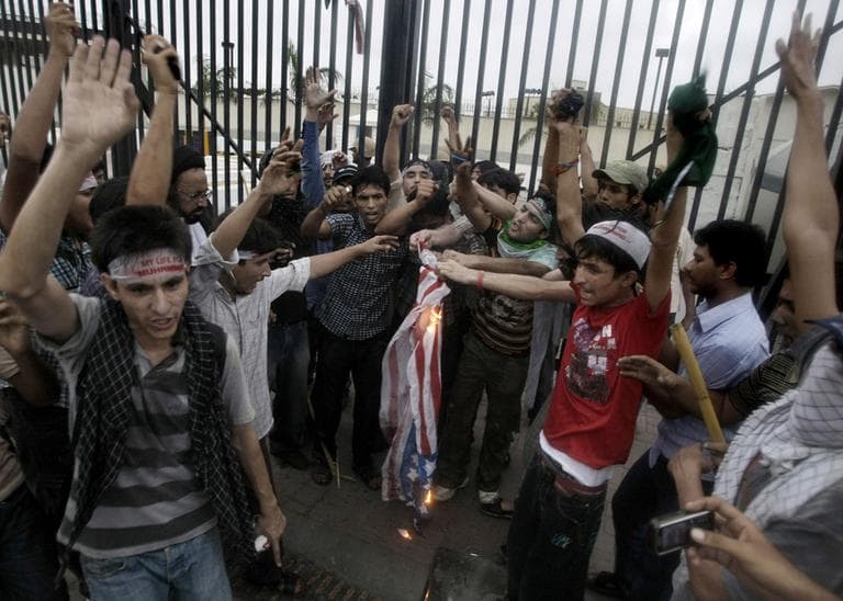 Pakistani protesters burn a representation of the U.S. flag at the entrance of the U.S. consulate in Karachi, Pakistan, Sunday, Sept. 16, 2012. (AP)