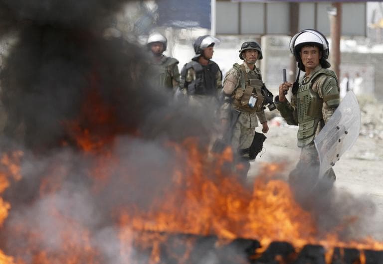 Afghan police stand by burning tires during a protest, in Kabul, Afghanistan, Monday. (AP)