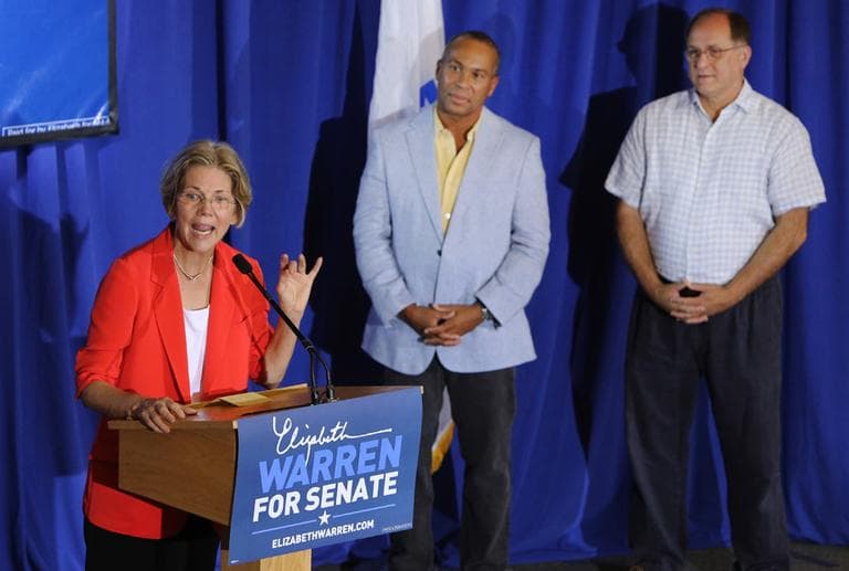 U.S. Senate candidate Elizabeth Warren speaks as Gov. Deval Patrick and U.S . Rep. Michael Capuano look on during a campaign rally, Saturday at Boston University. (AP)