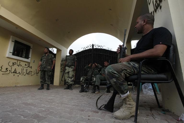 Libyan guards block the gate of the U.S. Consulate while Libyan investigators look into the attack that killed four Americans. (AP)