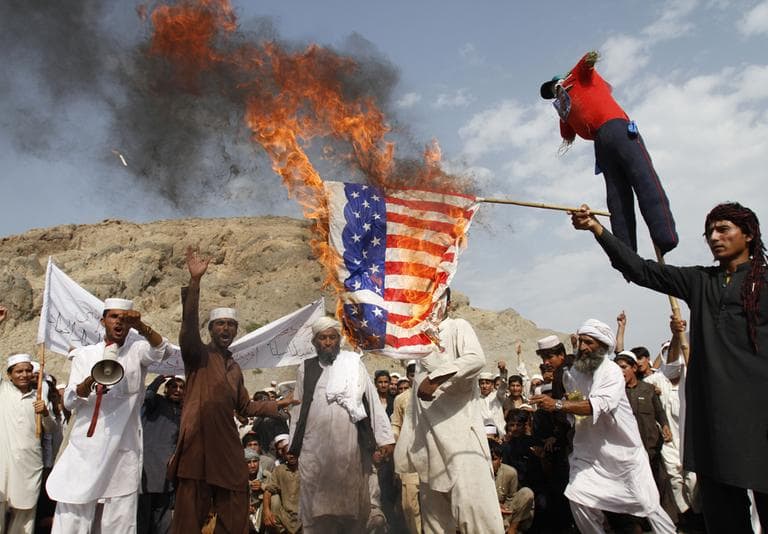  In this Friday, Sept. 14, 2012 file photo, Afghans burn the U.S. flag in Ghanikhel district of Nangarhar province, east of Kabul, Afghanistan, during a protest against an anti-Islam film which depicts the Prophet Muhammad as a fraud, a womanizer and a madman. Islamic militants seek to capitalize on anger over an anti-Islam video that was produced in the United States, saying a suicide bombing that killed a dozen in Afghanistan is revenge and calling for attacks on U.S. diplomats and facilities in North Africa. (AP)