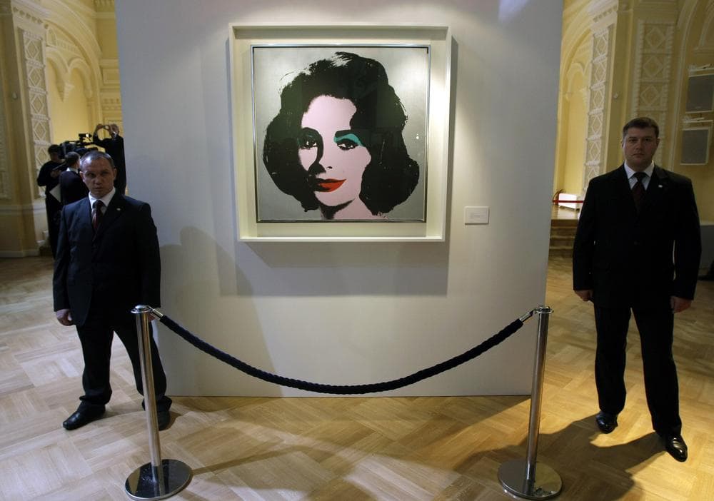 A portrait of Elizabeth Taylor by Andy Warhol from Elizabeth Taylor collection is shown in Moscow's GUM department store. (AP)