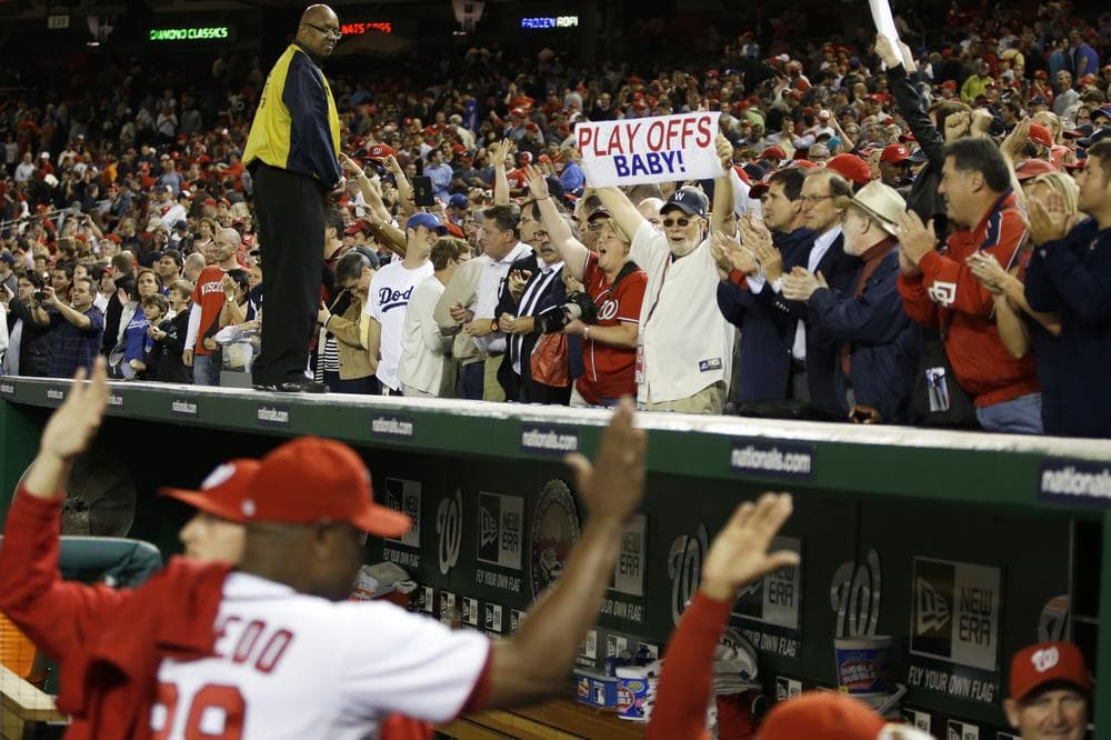 Washington Nationals players and fans celebrate Thursday's win over the L.A. Dodgers at Nationals Park. This victory clinched the first playoff spot for a Washington baseball team since 1933. (AP)