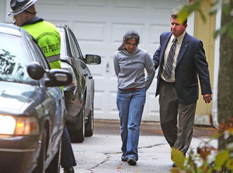 Annie Dookhan, center, is escorted to a cruiser outside her home in Franklin, Mass. on Friday. (AP)