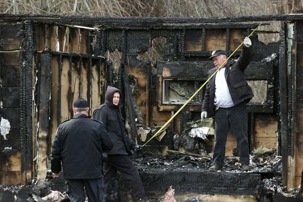 Investigators survey the site of The Station nightclub fire in West Warwick, R.I., in February 2003. (AP)