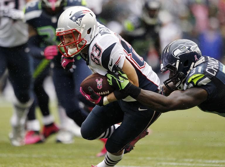 New England Patriots' Wes Welker carries the ball as Seattle Seahawks' Kam Chancellor tackles him in the first half  on Sunday, Oct. 14, 2012, in Seattle. (Elaine Thompson/AP)