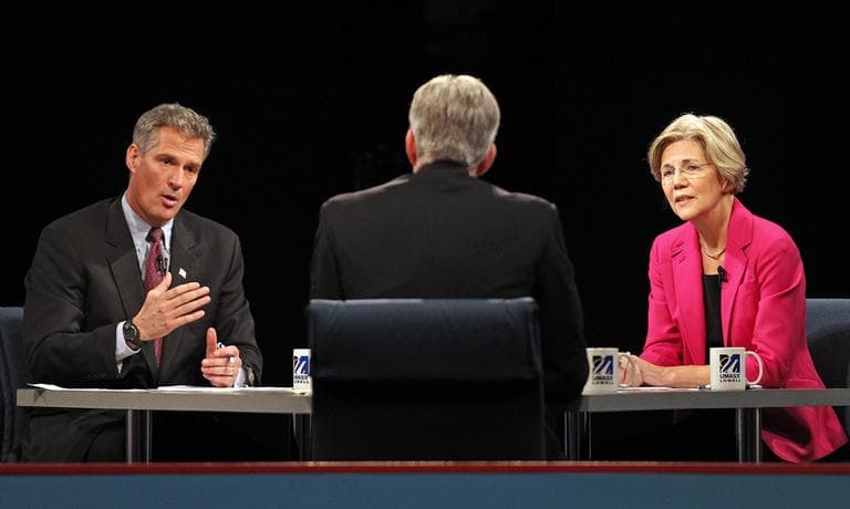 U.S. Sen. Scott Brown answers a question during a debate against challenger Elizabeth Warren Monday at the University of Massachusetts Lowell. Facing the candidates is moderator David Gregory. (AP/The Boston Herald, Pool)
