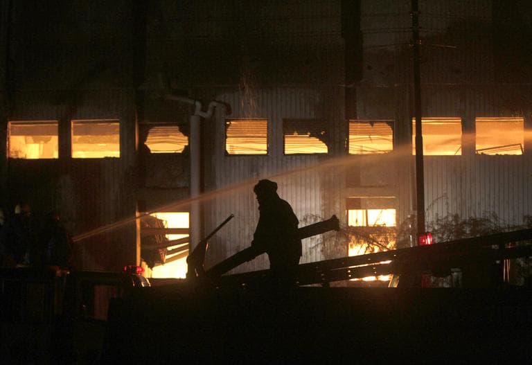 A fireman tries to extinguish a fire which broke out in a factory on Tuesday, Sept. 11, 2012 in Karachi, Pakistan. Factory fires in two of Pakistan's major cities killed 39 people and injured dozens more. (AP)