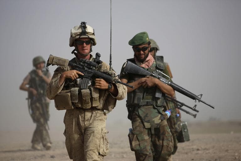 U.S. Marine squad leader Sgt. Matthew Duquette, left, of Warrenville, Ill., with Bravo Company, 1st Battalion 5th Marines walks with Afghan National Army Lt. Hussein, during in a joint patrol in Nawa district, Helmand province, southern Afghanistan in 2009. (AP)