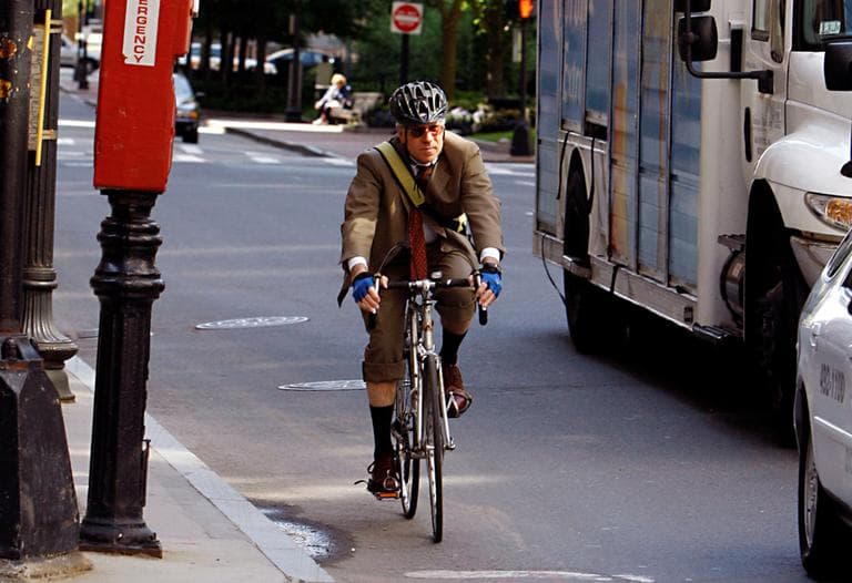 A man rides a bicycle on his morning work commute through downtown Boston. (AP)