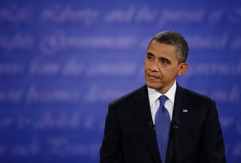 President Obama listens to Mitt Romney during the first presidential debate at the University of Denver, Wednesday. (David Goldman/AP)