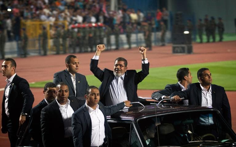 Egyptian President Mohammed Morsi waves to the crowd gathered in a Cairo stadium upon his arrival for a speech on the 6th of October national holiday marking the 1973 war with Israel. (Khalil Hamra/AP)