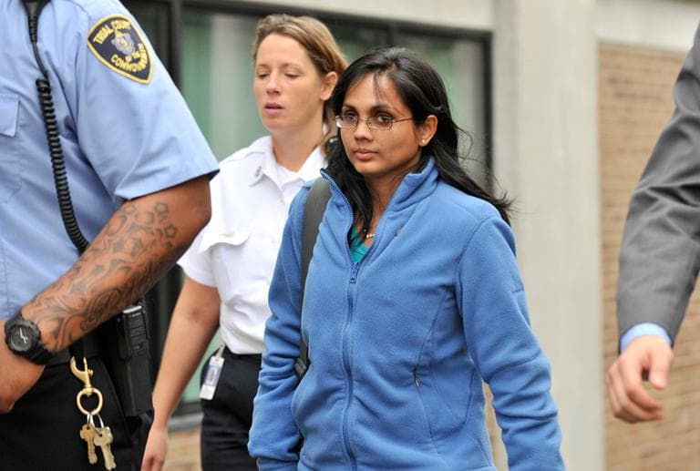 Accused former state chemist Annie Dookhan, center, leaves a Boston courthouse escorted by court officers and her lawyer after refusing to testify in a drug case against Shawn Drumgold Wednesday. (Josh Reynolds/AP)