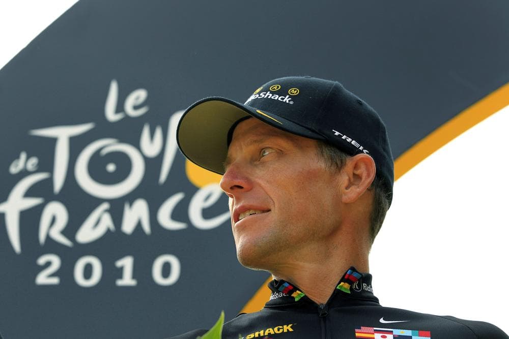Lance Armstrong stands on the podium after the 20th and final stage of the 2010 Tour de France. The U.S. Anti-Doping Agency took testimony from other cyclists and determined Armstrong was part of a doping scheme during the years he won his seven Tours. (Bas Czerwinski/AP)