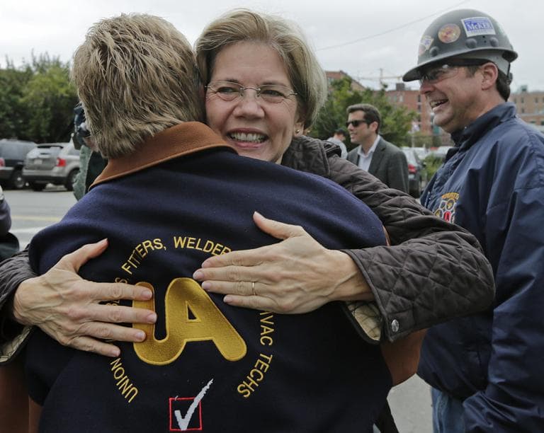 Elizabeth Warren embraces Tom McGrath, of Pipefitters Local 537, while campaigning in Boston on Tuesday. (Charles Krupa/AP)