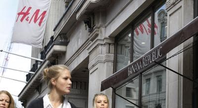 In this photo, people walk by chain stores Banana Republic and H&M on Regent Street in London, Friday, Sept. 3, 2010. (AP Photo/Sang Tan)
