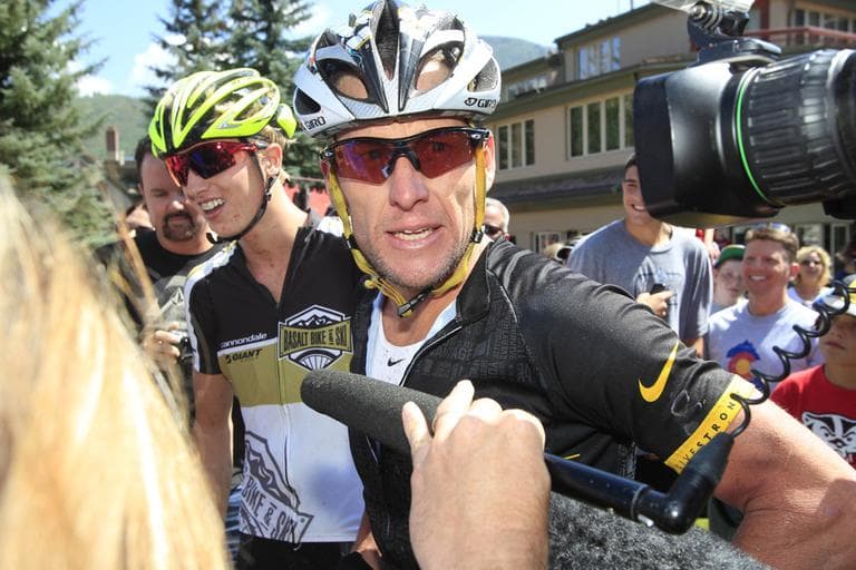 Lance Armstrong, front, talks to reporters after his second-place finish in the Power of Four mountain bicycle race in Aspen, Colo., in August. The race is the first public appearance for Armstrong since the U.S. Anti-Doping Association stripped him of his seven Tour de France championships and banned him for life from professional cycling. (AP/David Zalubowski)