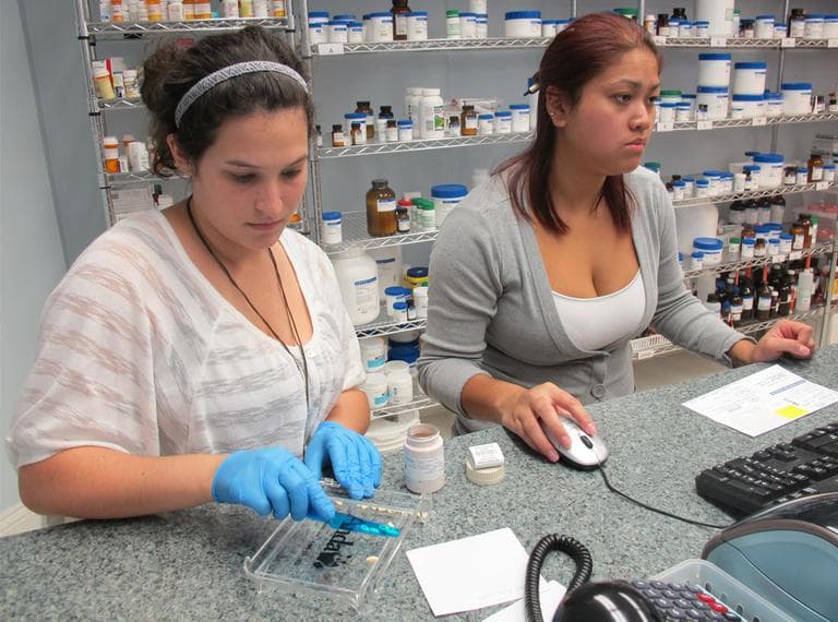 Workers at J.E. Pierce Apothecary, a compounding pharmacy in Brookline. (Curt Nickisch/WBUR)