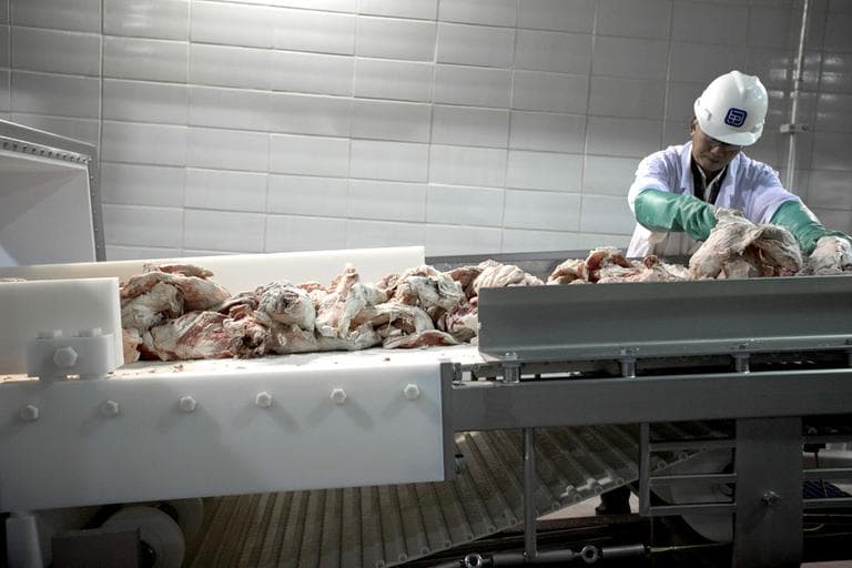 A worker sorts cuts of beef at a plant in Nebraska in March. A new report says for-profit companies are quietly taking over food safety inspections. (AP/Nati Harnik)