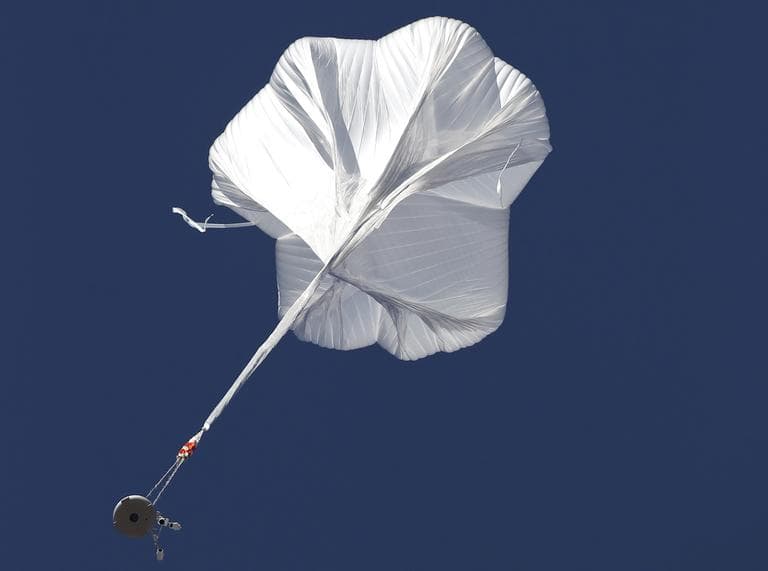 The capsule and attached helium balloon carrying Felix Baumgartner lifts off as he attempts to break the speed of sound with his own body by jumping from a space capsule lifted by a helium balloon, Sunday, Oct. 14, 2012, in Roswell, N.M. (Ross D. Franklin/AP)