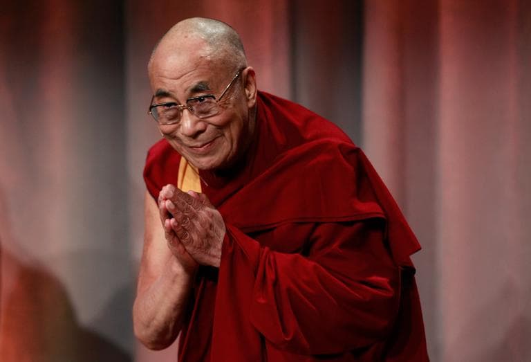 Tibetan exiled spiritual leader the Dalai Lama bows to an audience as he takes the stage at the start of an event called &quot;Beyond Religion: Ethics, Values and Well-Being,&quot; at a Boston hotel Sunday. (Steven Senne/AP)