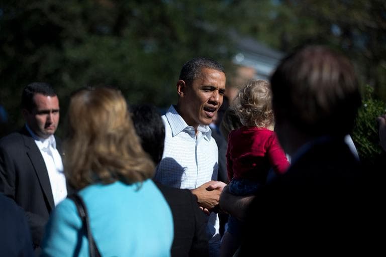 President Obama greets people outside a campaign field office Sunday in Williamsburg, Va. (Carolyn Kaster/AP)