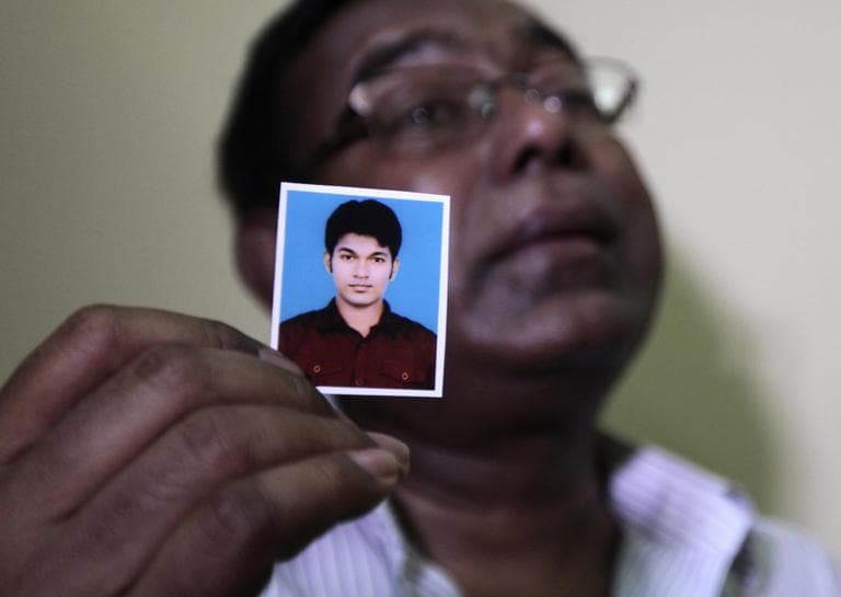 Bangladeshi Quazi Ahsanullah displays a photograph of his son Quazi Mohammad Rezwanul Ahsan Nafis, as he weeps in his home in the Jatrabari neighborhood in north Dhaka, Bangladesh on Thursday. The FBI arrested 21-year-old Nafis after he tried to detonate a fake 1,000-pound car bomb, according to a criminal complaint. His family said Nafis was incapable of such actions. (AP/A.M. Ahad)