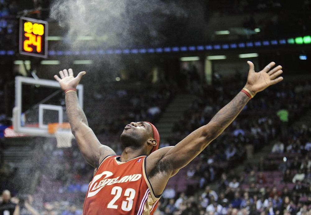 LeBron James throws chalk in the air before a game. He took this routine along with his talents to South Beach when he joined the Miami Heat. The NBA's new 90-second rule may threaten this and other player routines between bench and tip-off. (AP/Bill Kostroun)