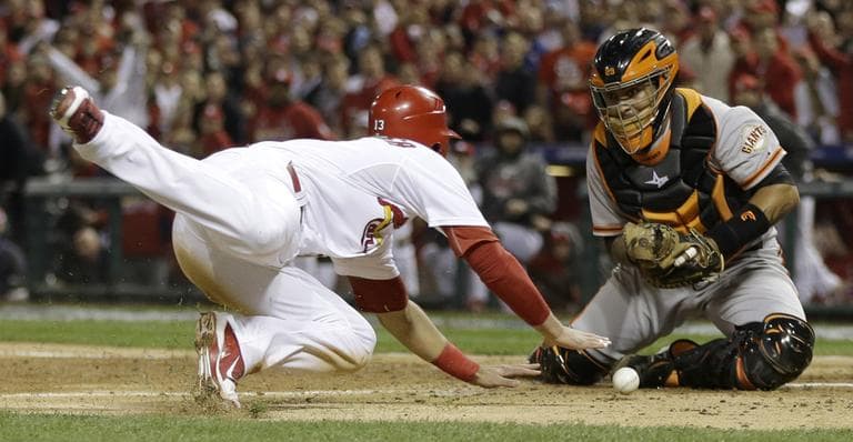 San Francisco Giants catcher Hector Sanchez can't handle the throw as St. Louis Cardinals' Matt Carpenter scores from second on a single by Matt Holliday, during the fifth inning of Game 4 of the National League championship series on Thursday. (AP/David J. Phillip)