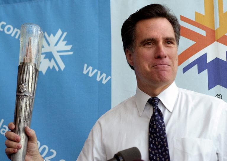 Mitt Romney holds the Olympic torch during a news conference in Salt Lake City in 2001. (Douglas C. Pizac/AP)