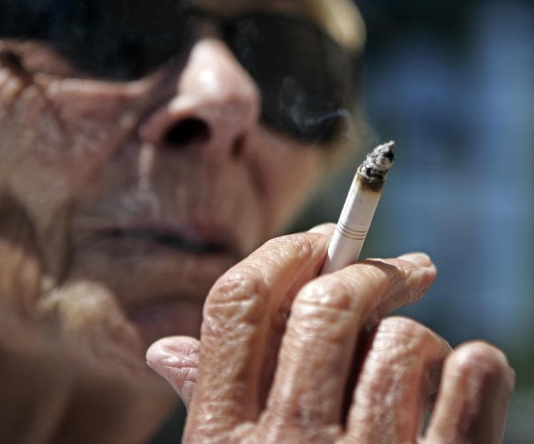 Helen Heinlo smokes outside of a coffee shop in Belmont, Calif., where smoking is banned in apartment buildings and condominium developments. The law also prohibits puffing on streets and sidewalks during public events and at outdoor workplaces. (AP/Paul Sakuma)