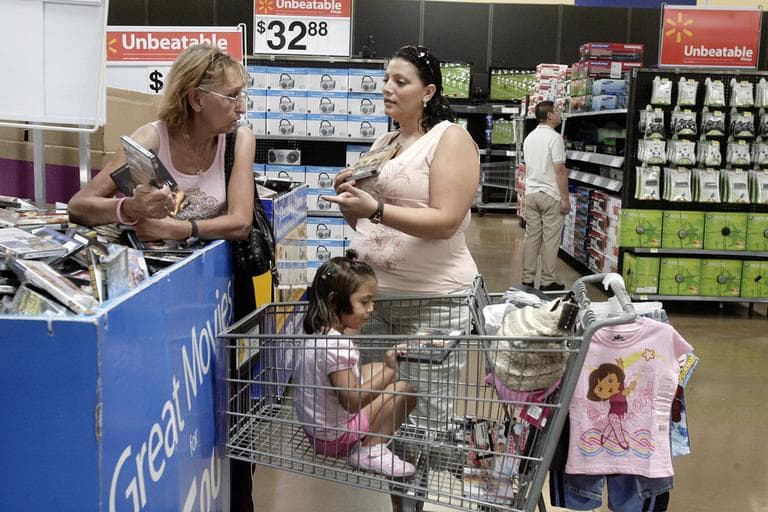 A mother shops for movies at a Walmart Supercenter in Rosemead, Calif. (AP/Ric Francis)