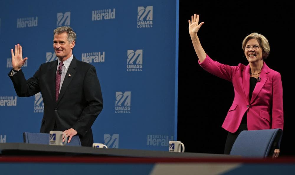 Republican U.S. Sen. Scott Brown, left, and Democratic challenger Elizabeth Warren wave to the audience prior to a debate sponsored by the Boston Herald at the University of Massachusetts in Lowell, Mass., Monday, Oct. 1, 2012. (AP)