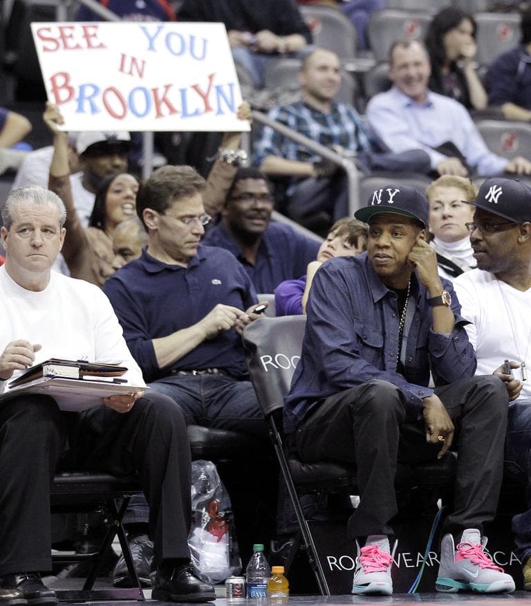 Rapper Jay-Z, bottom right, who is part owner of the Nets, attends the team's final NBA basketball home game as the "New Jersey Nets," before the team packs up and move to Brooklyn. (AP/Julio Cortez)
