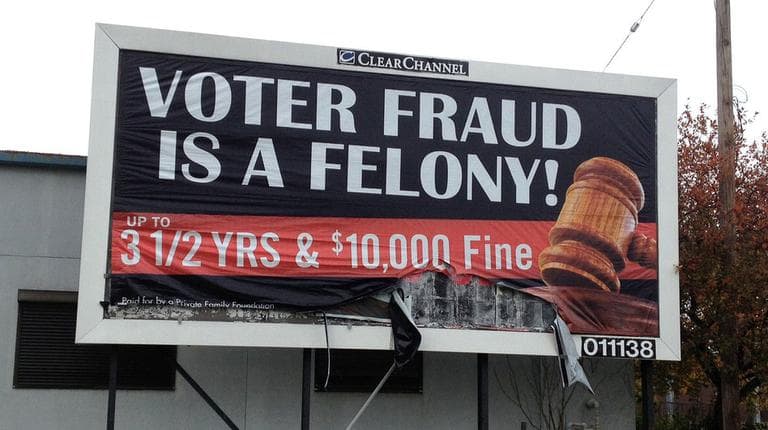 An anonymous "family foundation" is paying for billboards warning against voter fraud, like this one in a minority neighborhood on the east side of Cleveland. Clear Channel, which owns the space, is bowing to community pressure to take the ads down. (NPR/Ken Barcus)