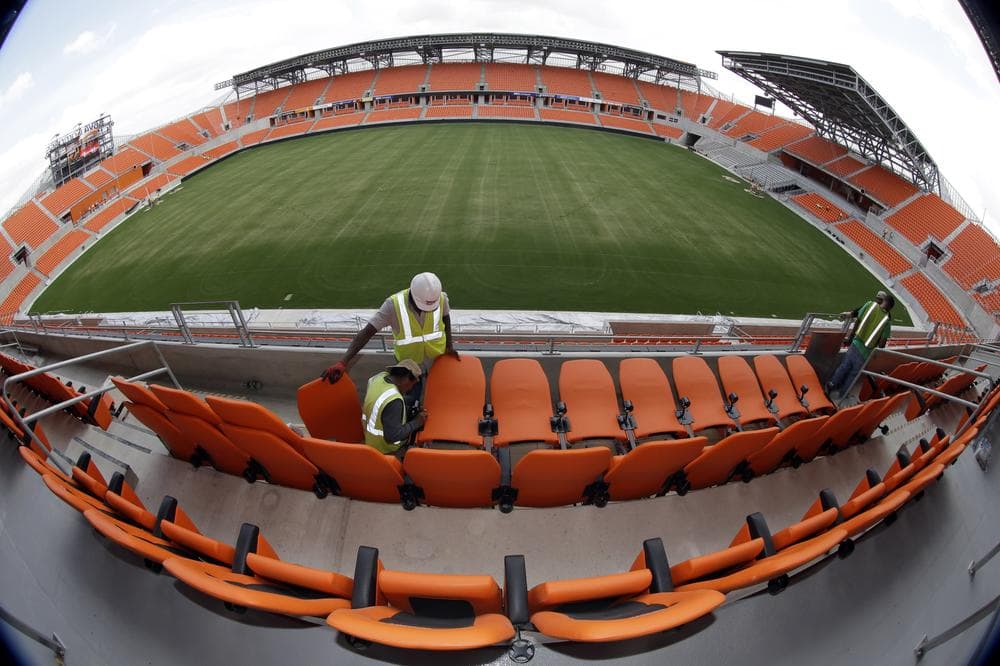 Workers install seats at the Houston Dynamo's new stadium. The 22,000-seat BBVA Compass Stadium opened in May. (David J. Phillip/AP)