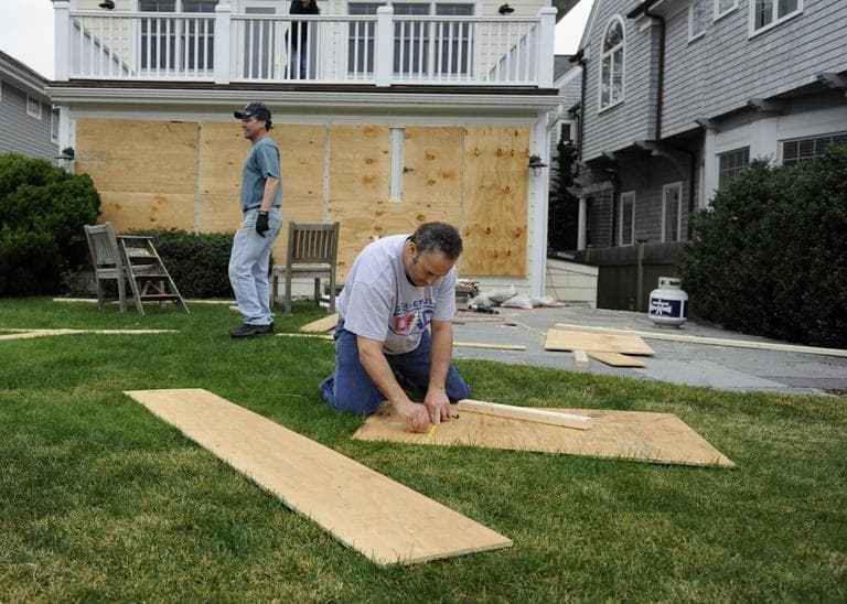 Jeff Babushkin, right, and Brad Purcell board up Purcell's home in Fairfield, Conn., Sunday, Oct. 28, 2012. (Jessica Hill/AP)