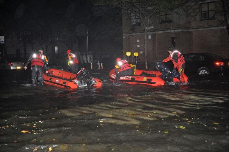 FDNY inflatable boats travel along 14th street towards the East River on a rescue mission in the wake of Hurricane Sandy on Monday. (Louis Lanzano/AP)
