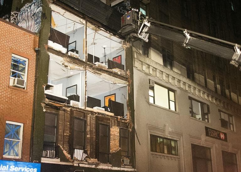 The facade of a four-story building on 14th Street and 8th Avenue collapsed onto the sidewalk on Monday in New York. (John Minchillo/AP)