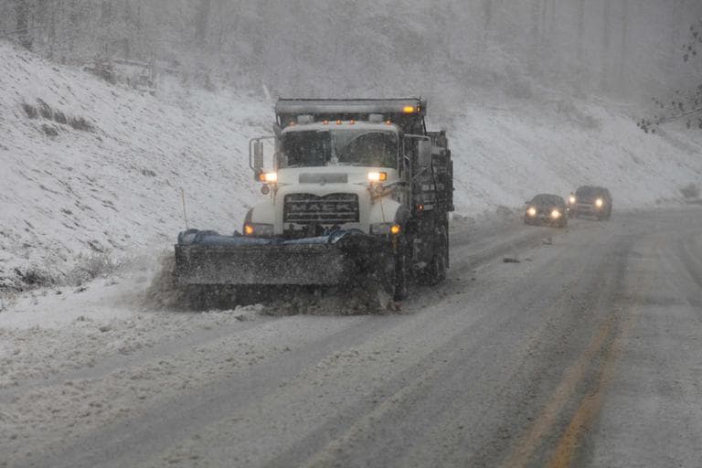 Snow plows thunder through the mountains of West Virginia as the superstorm begins it's raking of the region on Monday evening. (Robert Ray/AP)