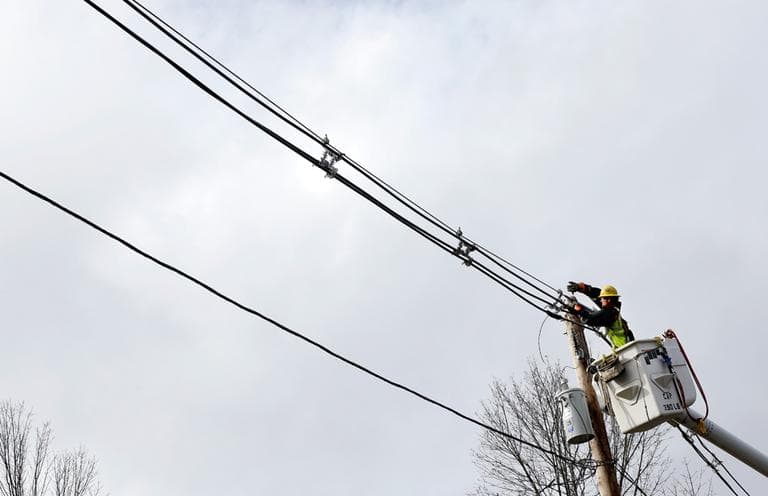 A utility crewmember works to restore power in Andover on Tuesday, following Sandy. (Elise Amendola/AP)