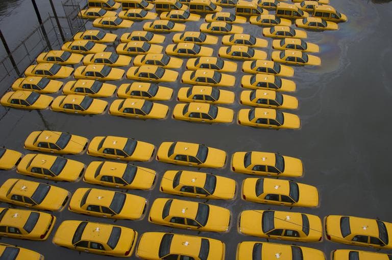 A parking lot full of yellow cabs in Hoboken, N.J., is flooded on Tuesday, as a result of Hurricane Sandy. (Charles Sykes/AP)