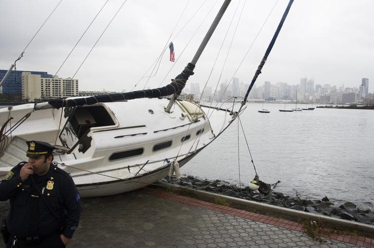 A boat rests on the waterfront of the Hudson River in Hoboken, N.J. across from New York City, background right, on Tuesday, after superstorm Sandy made landfall in New Jersey Monday evening. (Charles Sykes/AP)
