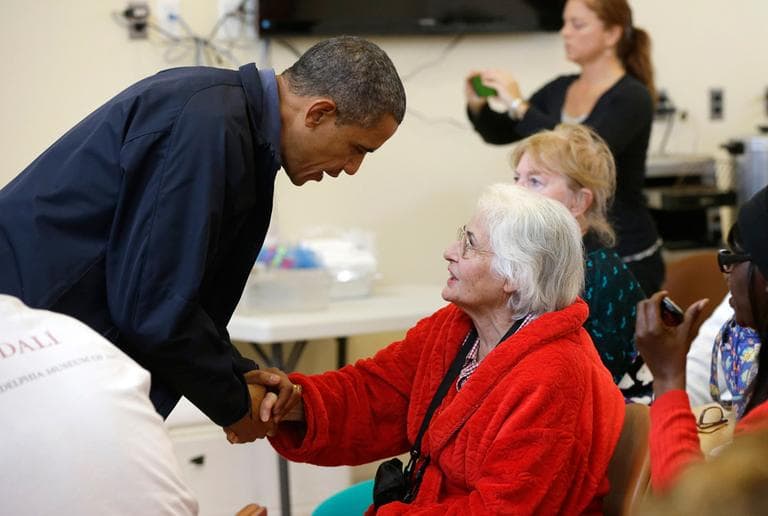 President Obama meets with a local resident at the Brigantine Beach Community Center in Brigantine, N.J., Wednesday. Obama traveled to the Atlantic Coast to see firsthand the relief efforts after Superstorm Sandy. (Pablo Martinez Monsivais/AP)