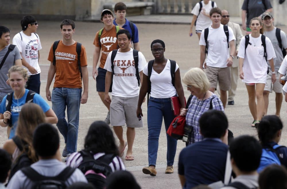 In this Thursday, Sept. 27, 2012 photo, students walk through the University of Texas at Austin campus in Austin, Texas. This giant flagship campus – once so slow to integrate – is now awash in color, among the most diverse the country if not the world. (AP)