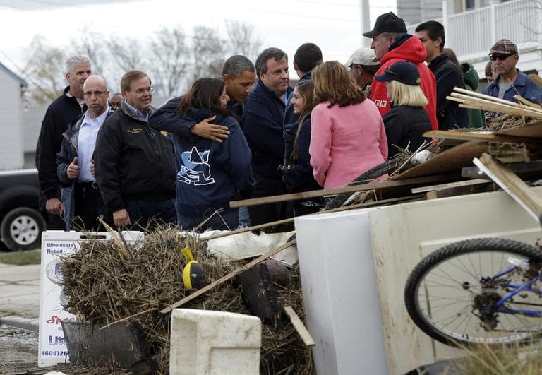 President Barack Obama, center, and and Gov. Chris Christie meet with local residents as they tour neighborhood effected by superstorm Sandy, Wednesday, Oct. 31, 2012 in Brigantine, N.J. Also with them is Sen. Bob Menendez, D-N.J., left. (AP)