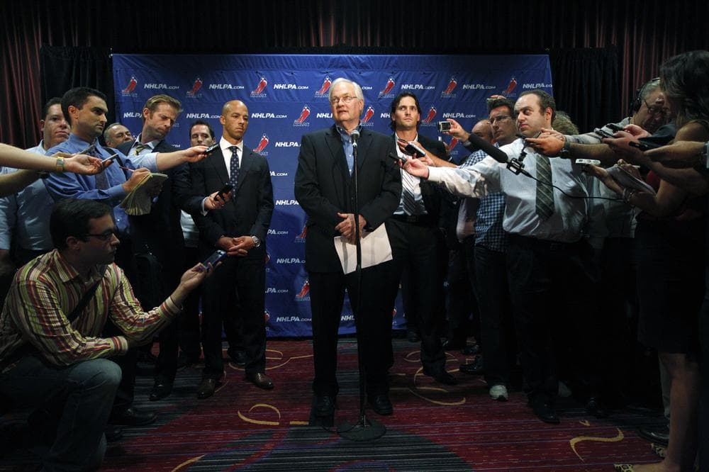 Reporters surround Donald Fehr, the executive director of the NHL Players' Association. Aside from continuing negotiations between the association and the NHL, sports reporters will have limited hockey content to cover in the next month. (Mary Altaffer/AP)