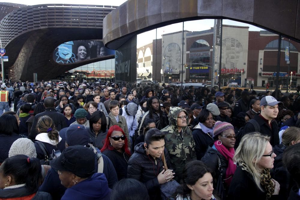 Instead of hosting the Brooklyn Nets' home opener on Thursday, the Barclays Center was visited by thousands of commuters who spent up to three hours waiting for a bus. (AP Photo/Seth Wenig)