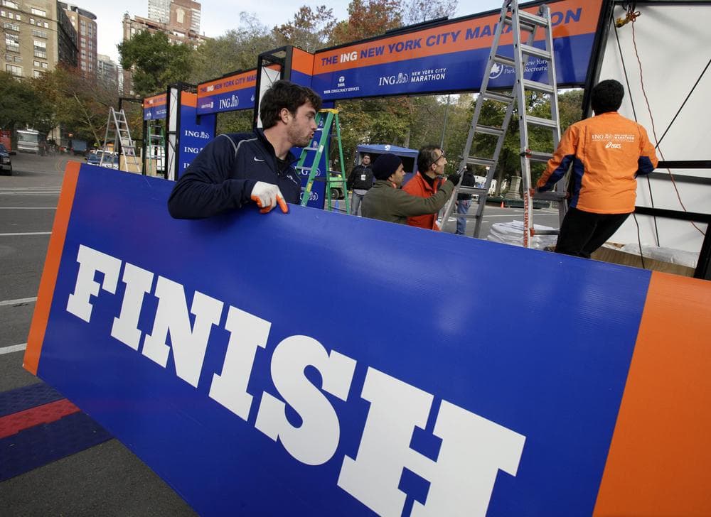 Workers prepare the finish line for the 43rd New York City Marathon in Central Park on Thursday. The race will go ahead as scheduled despite logistical issues resulting from Hurricane Sandy. (Richard Drew/AP)